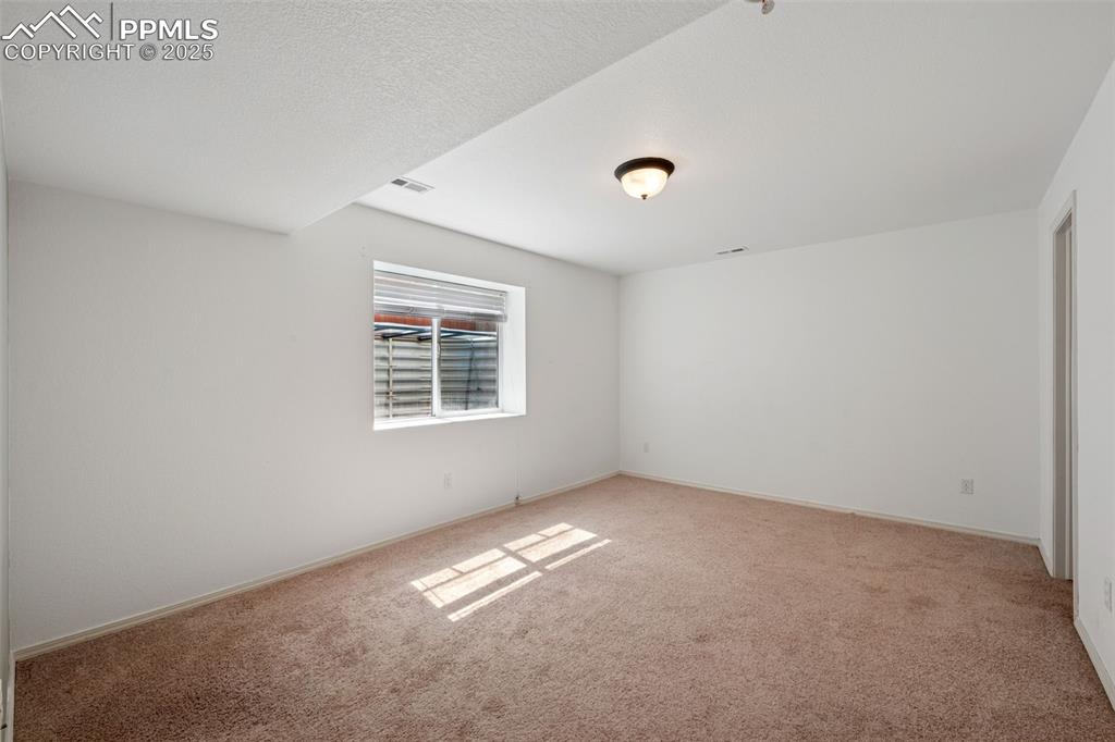 Image 36 of 38: Unfurnished room with light carpet and baseboards