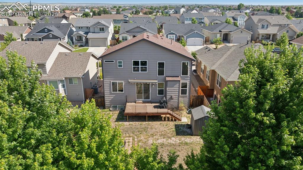 Image 5 of 38: Back of house featuring a residential view and a wooden deck