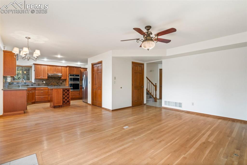 Image 10 of 26: Kitchen featuring open floor plan, appliances with stainless steel finishes