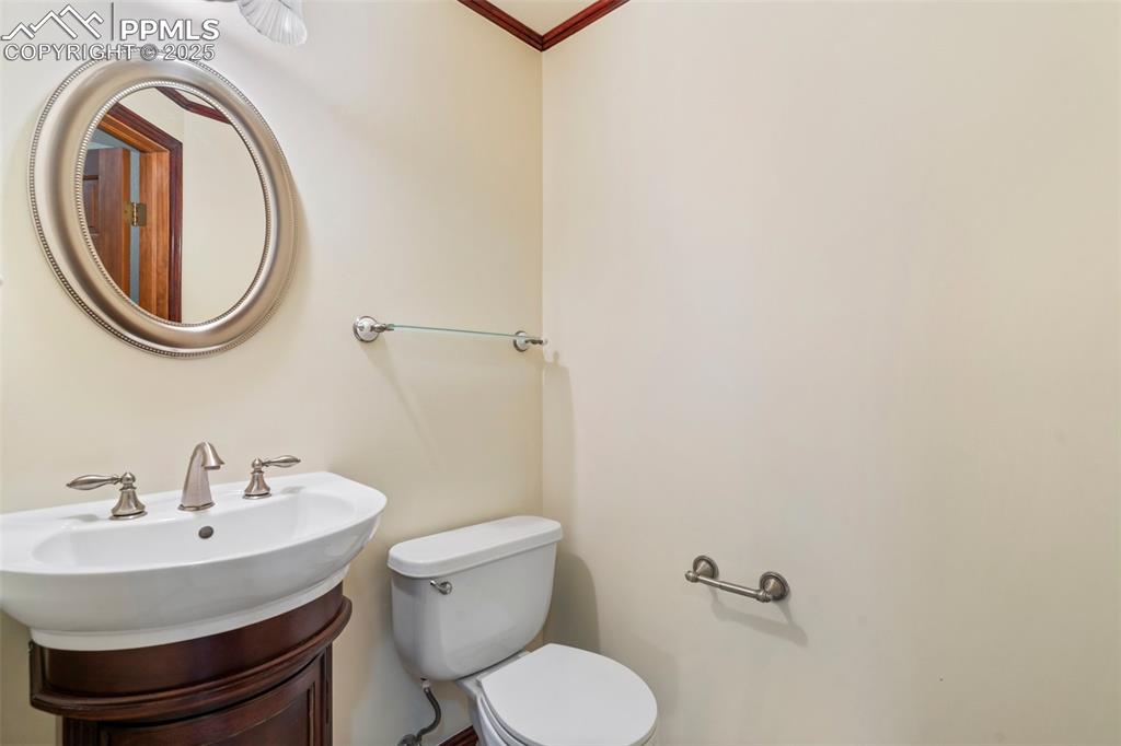 Image 12 of 26: Bathroom with toilet and ornamental molding