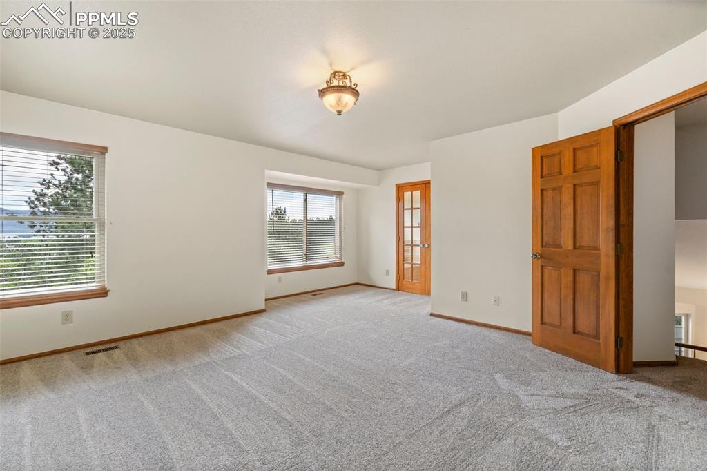 Image 14 of 26: Spare room with light carpet