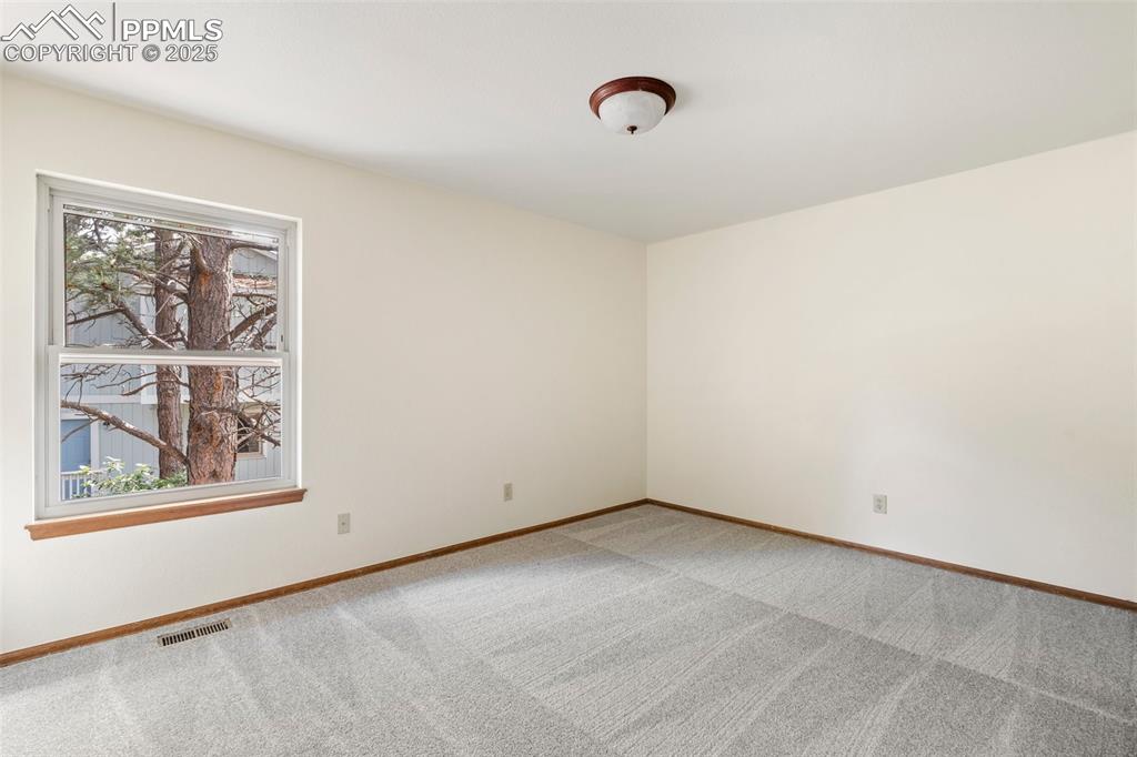 Image 17 of 26: Unfurnished room featuring light carpet and baseboards