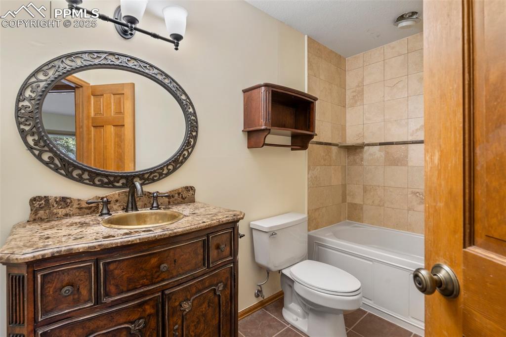 Image 19 of 26: Bathroom featuring tile patterned floors, vanity, and bathing tub / shower