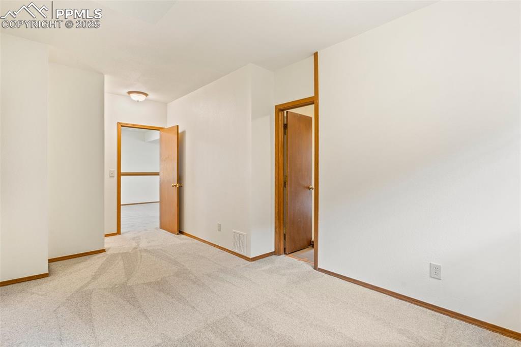 Image 21 of 26: Empty room featuring carpet floors and baseboards
