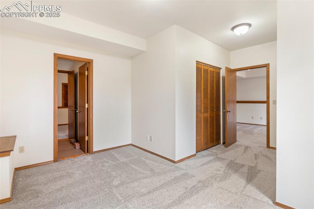Image 23 of 26: Carpeted spare room featuring baseboards