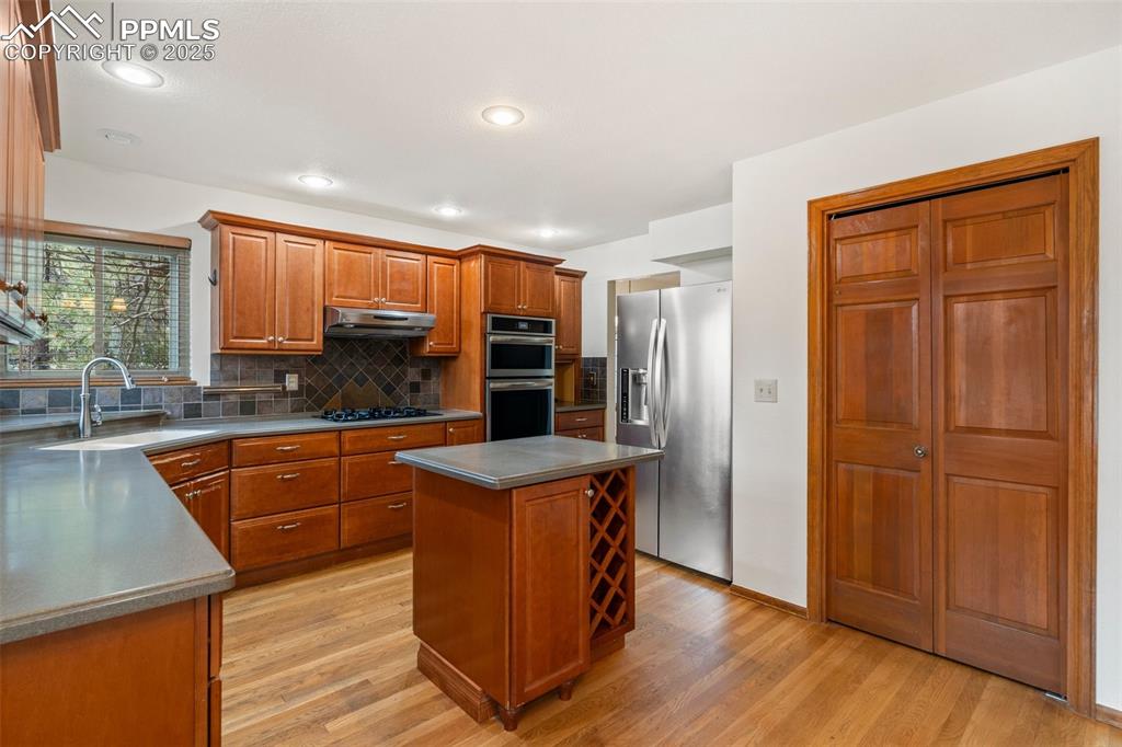 Image 6 of 26: Kitchen with appliances with stainless steel finishes, under cabinet range