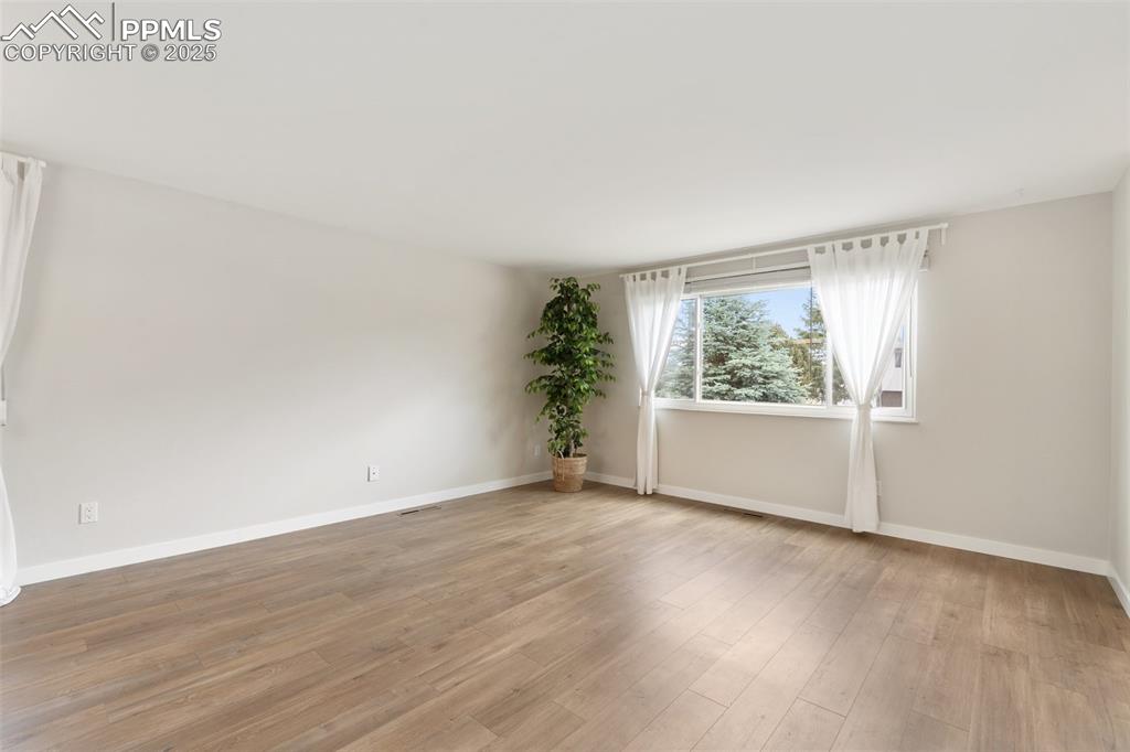Image 13 of 50: The great room features new luxury vinyl plank floors, fresh paint, and a p
