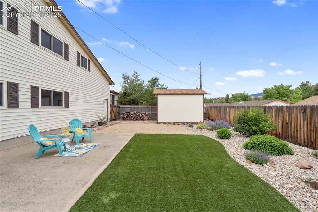 Image 41 of 50: Turf yard with gorgeous landscaping and a privacy fenct!