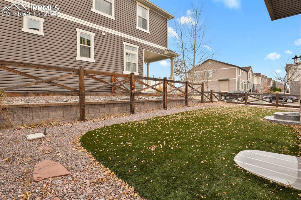Image 25 of 30: 
Backyard featuring stampled concrete and pet friendly artificial turf.