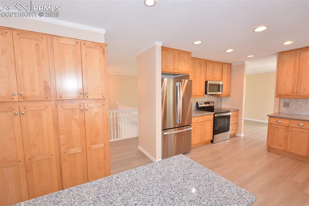 Image 13 of 50: Kitchen has plenty of cabinets for storage