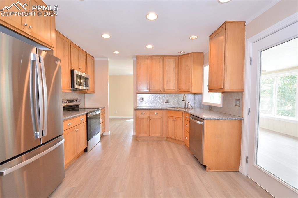 Image 14 of 50: Kitchen showing entrance into sunroom
