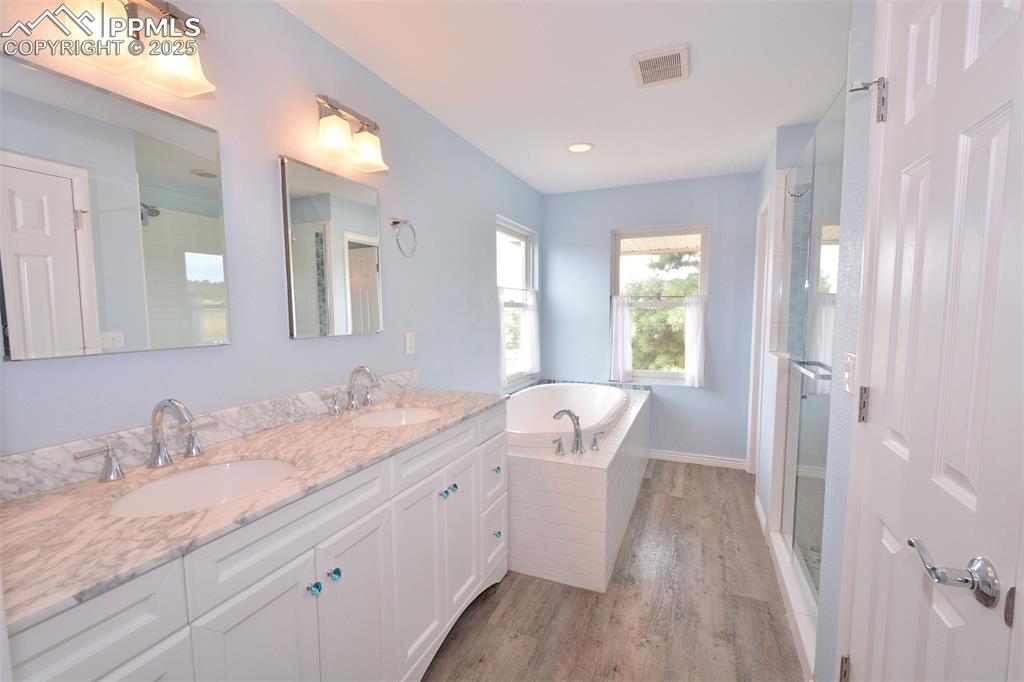 Image 21 of 50: Master Bathroom with double vanity, soaking tub, spa shower and linen close