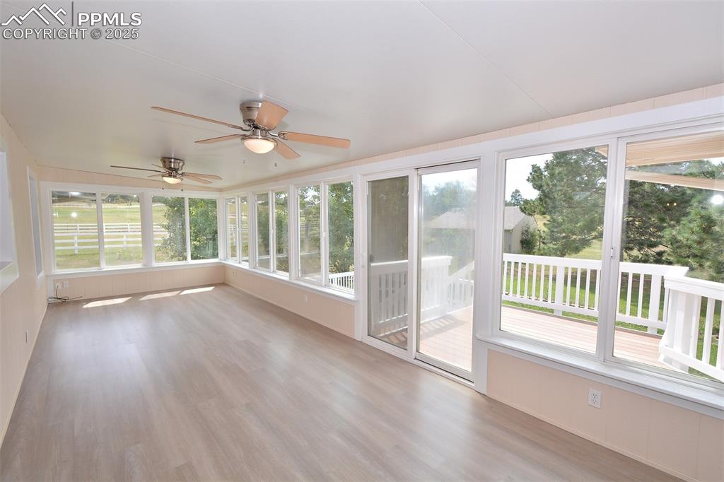 Image 27 of 50: Light and bright sunroom with sliding door to deck