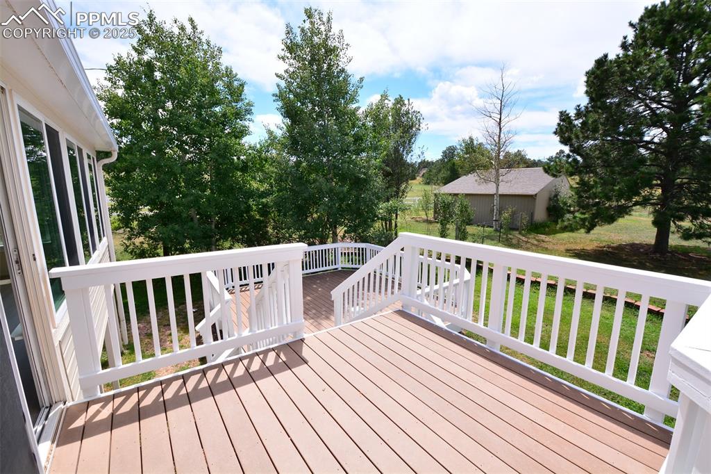 Image 33 of 50: Deck with barn and backyard view
