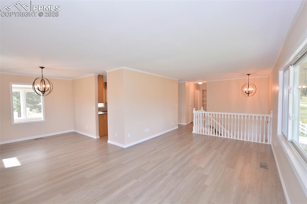 Image 7 of 50: Open living/dining room with LVP flooring