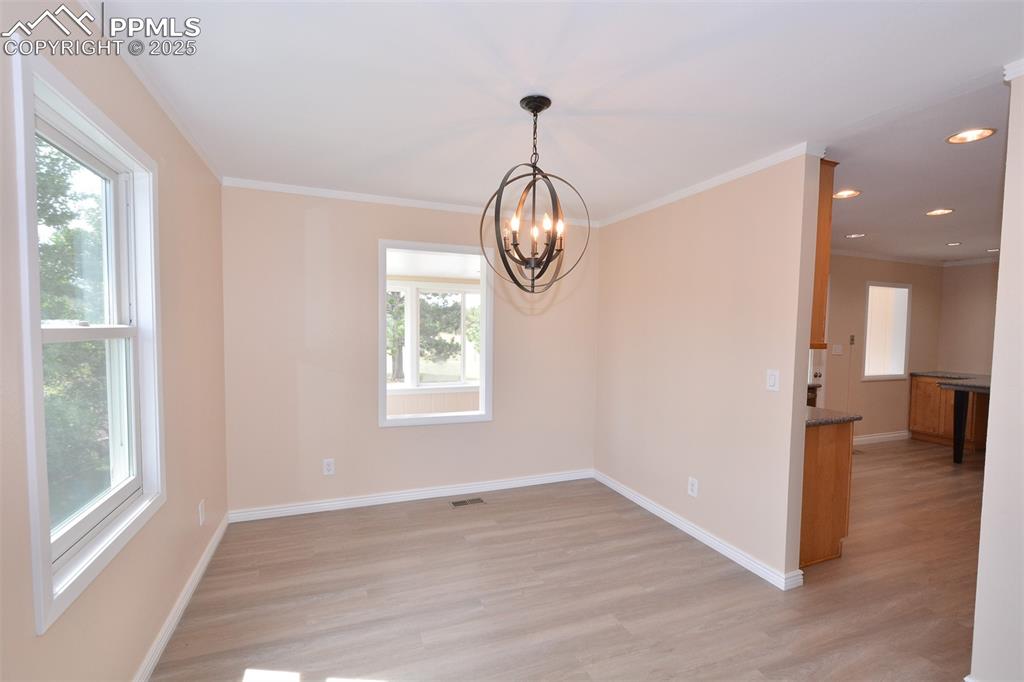 Image 9 of 50: Dining Room with open window view of sunroom