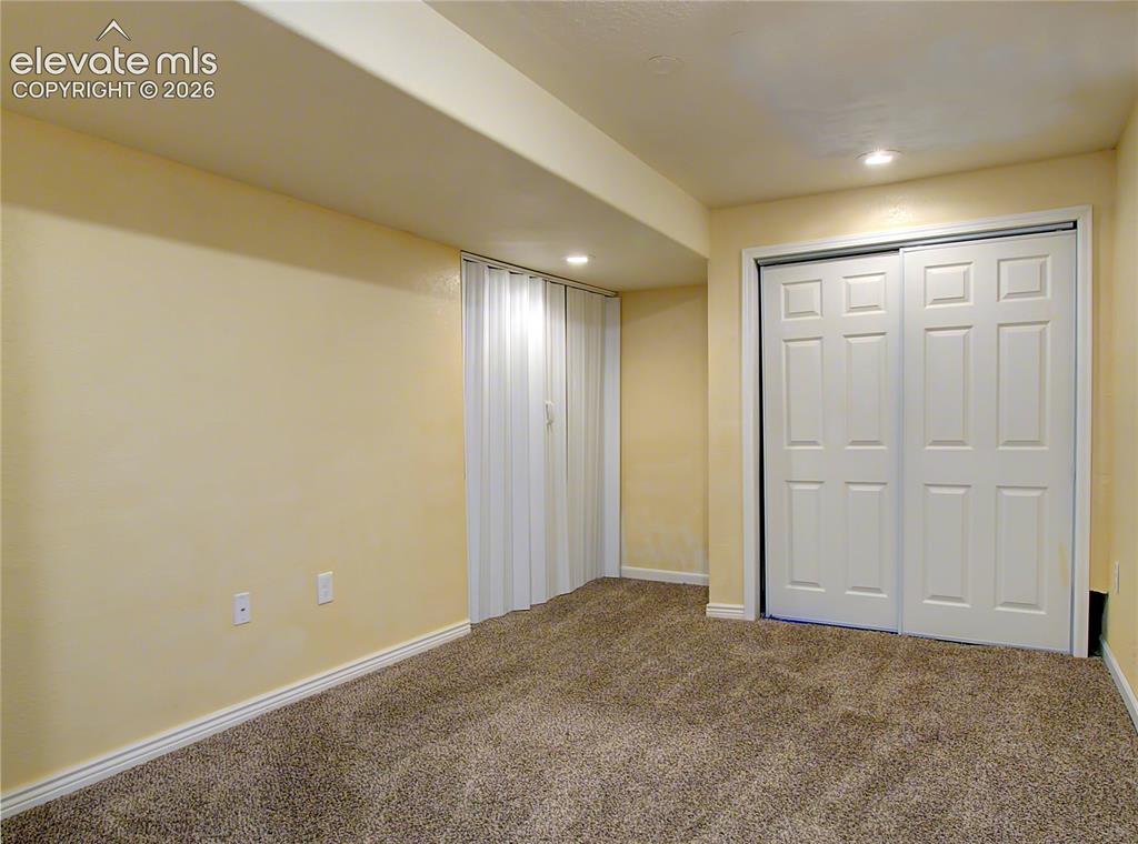 Image 20 of 28: Carpeted room with recessed lighting