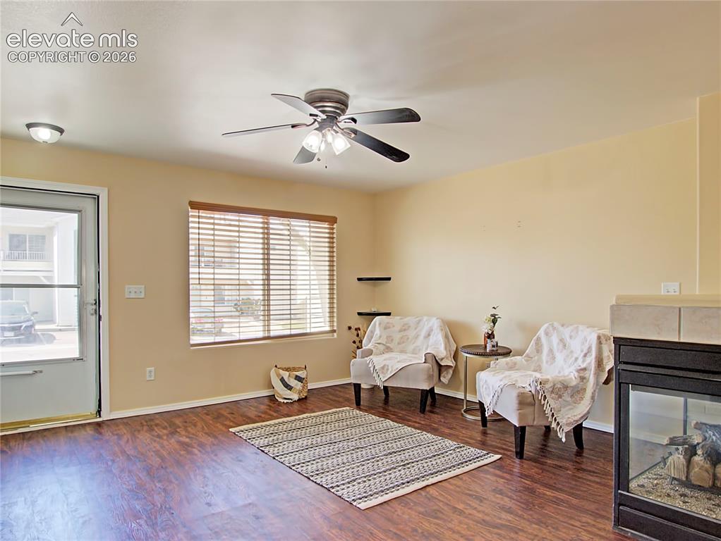 Image 5 of 28: Living area featuring wood-finish flooring, a ceiling fan with integrated l