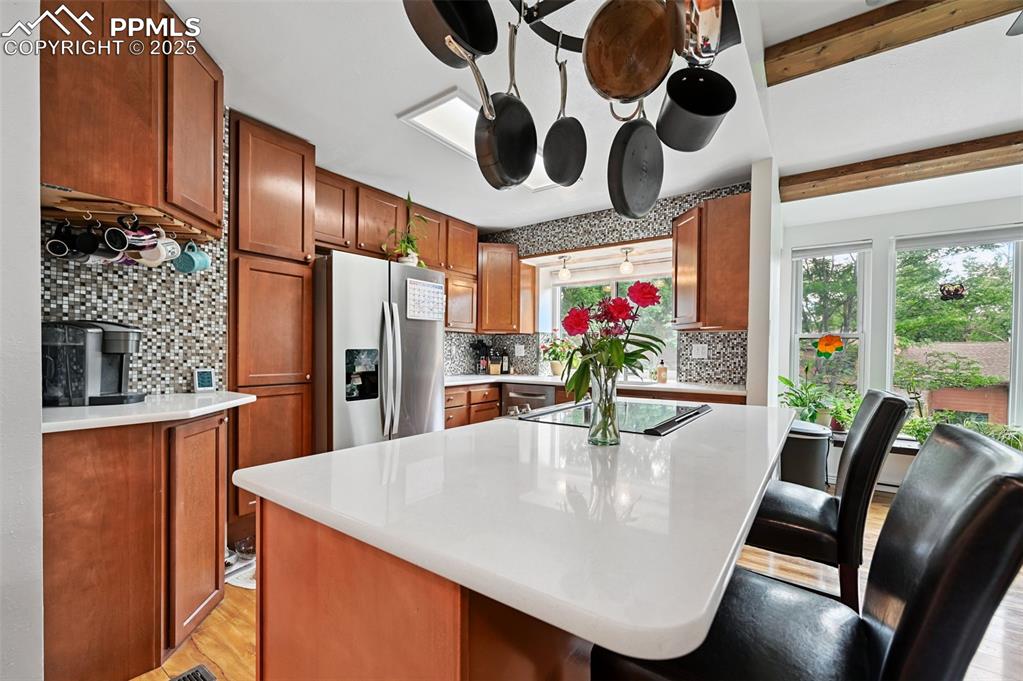 Image 10 of 42: Plenty of room to food prep and entertaining at the island bar. Also, notic