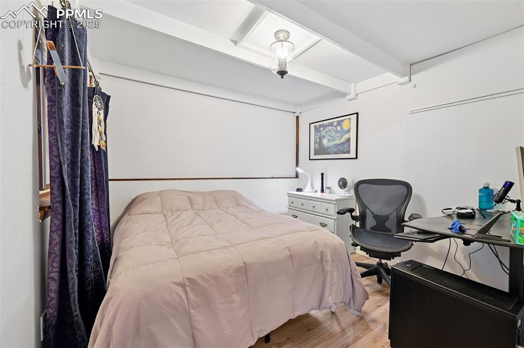 Image 27 of 42: The 3rd bedroom is located on the lower level and features a sliding door a