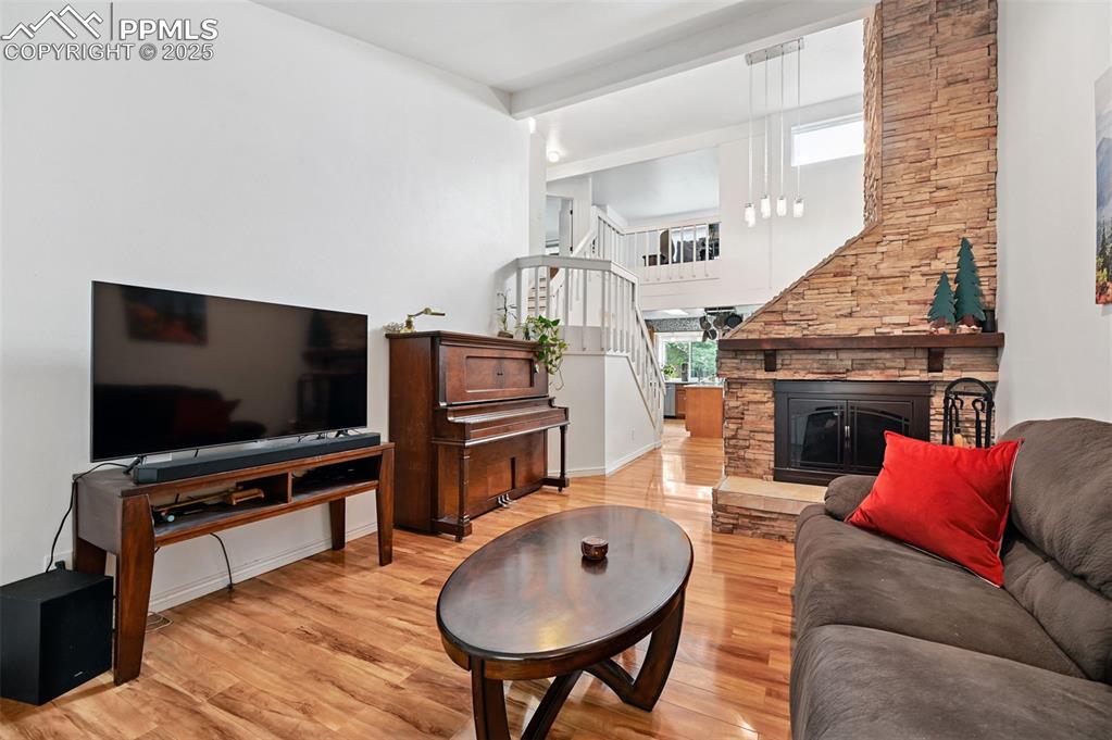 Image 3 of 42: Living room with wood fireplace, that also offers a gas line.