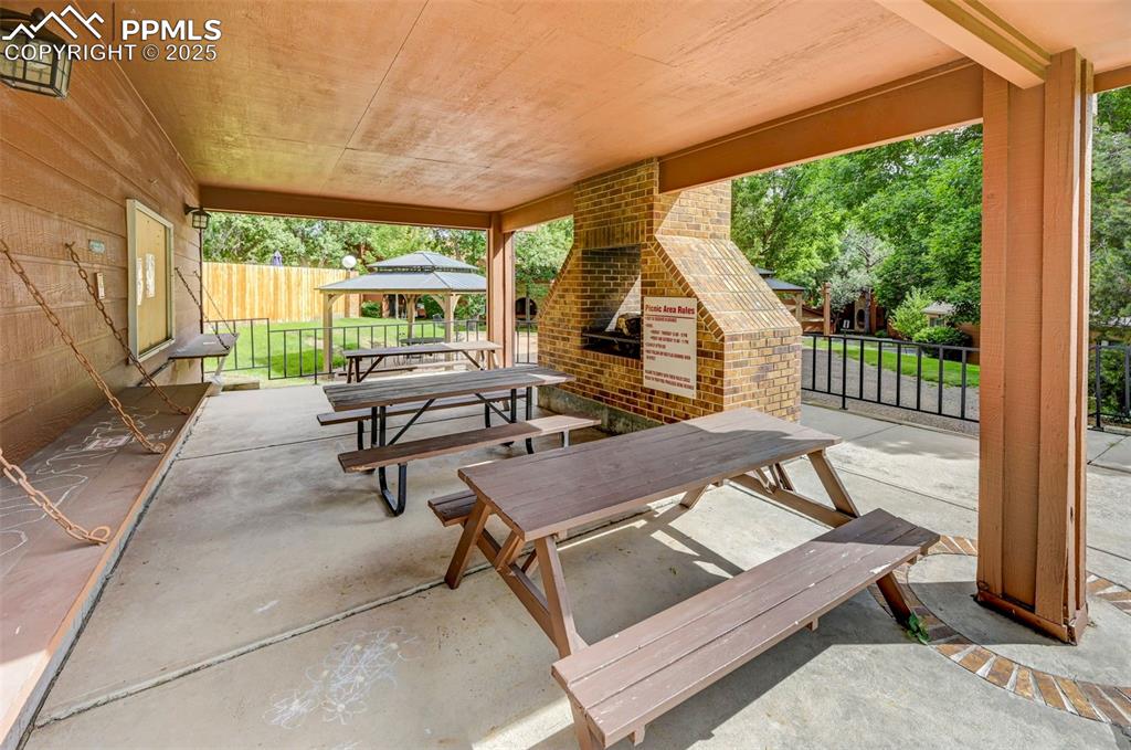 Image 35 of 42: Covered patio by the pool.