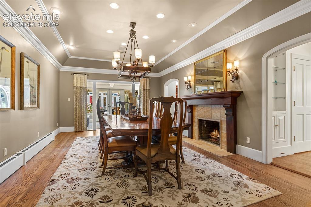 Image 12 of 50: Formal dining room with an entry to the sun room