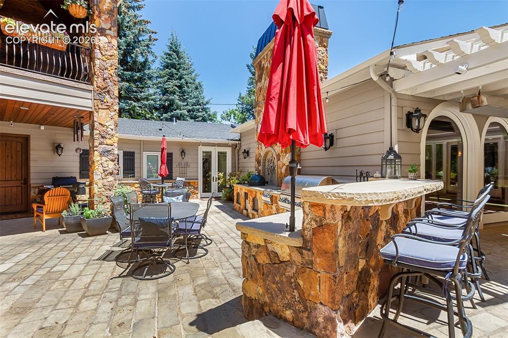 Image 18 of 50: Large patio and grilling area for indoor/ outdoor entertaining.