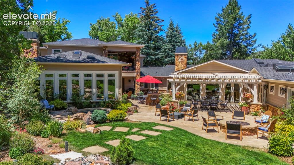 Image 2 of 50: Water fall, hot tub, fire pit, outdoor entertaining area, BBQ area, conserv