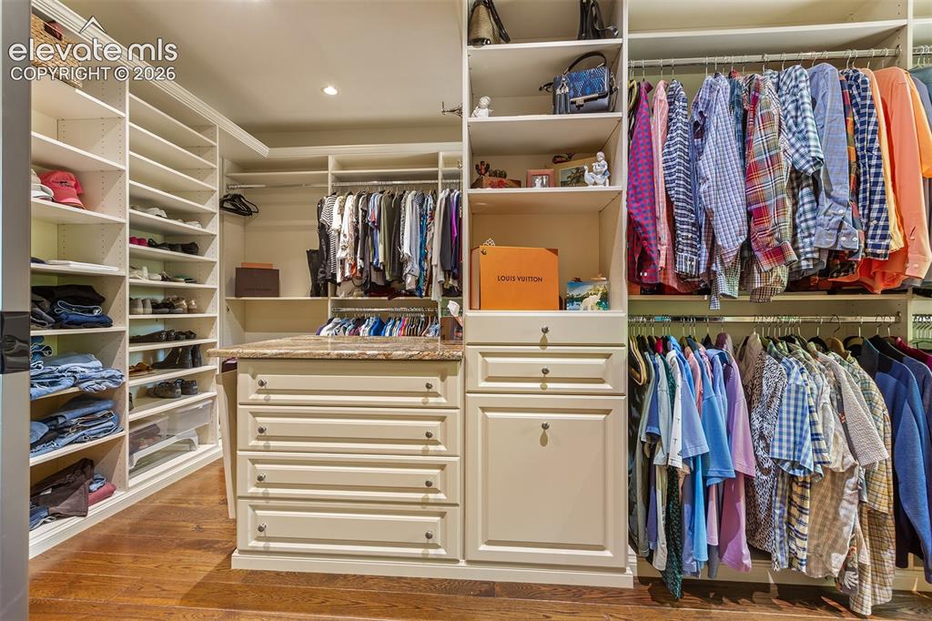 Image 36 of 50: Beautiful walk in closet with a washer and dryer for upper primary bedroom