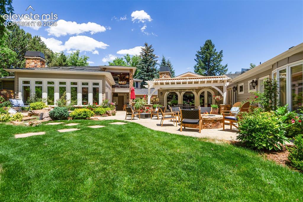 Image 45 of 50: Conservatory on left, 4 level pergola and entry to living room center, main