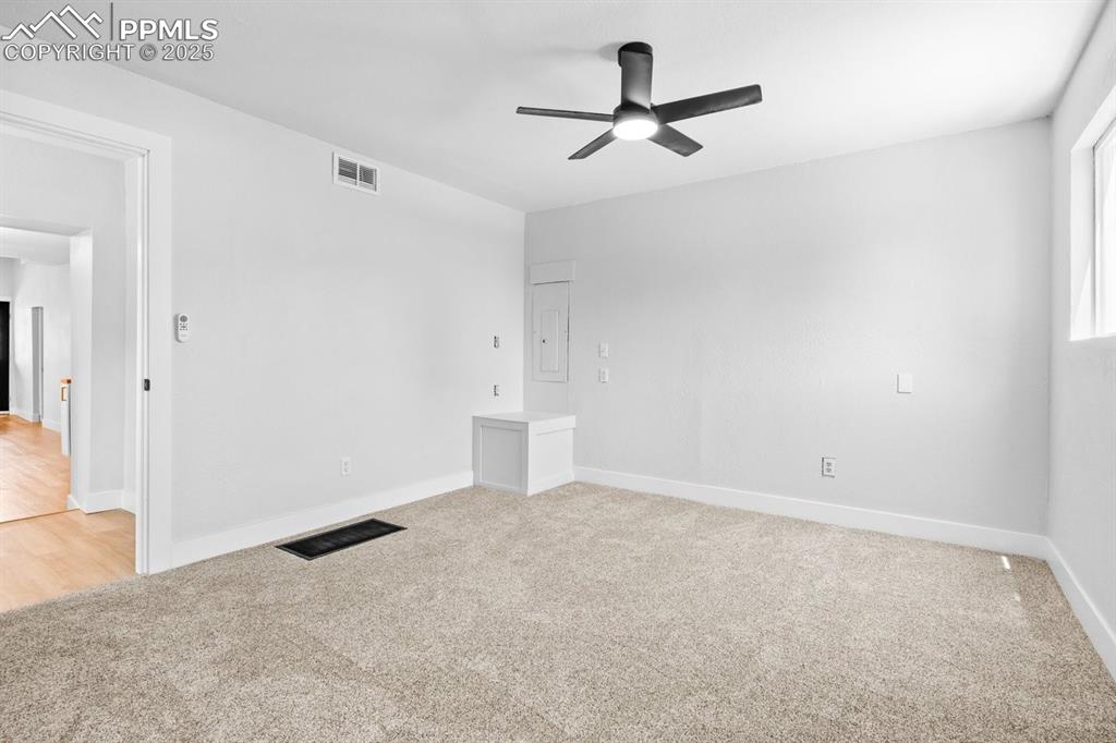 Image 14 of 41: Empty room featuring carpet floors and ceiling fan