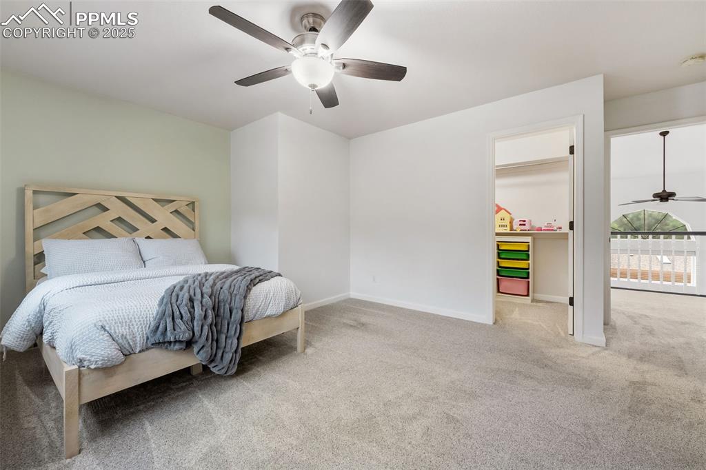 Image 14 of 44: Carpeted bedroom with a spacious closet and ceiling fan