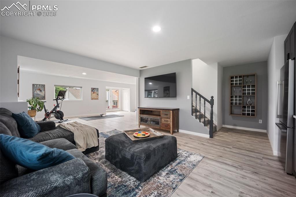 Image 28 of 44: Living room featuring light wood finished floors, recessed lighting, and st