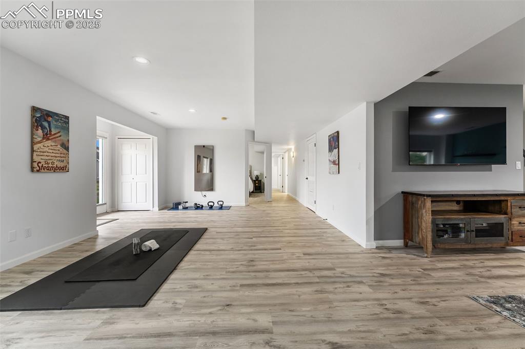 Image 30 of 44: Unfurnished living room featuring wood finished floors and recessed lightin