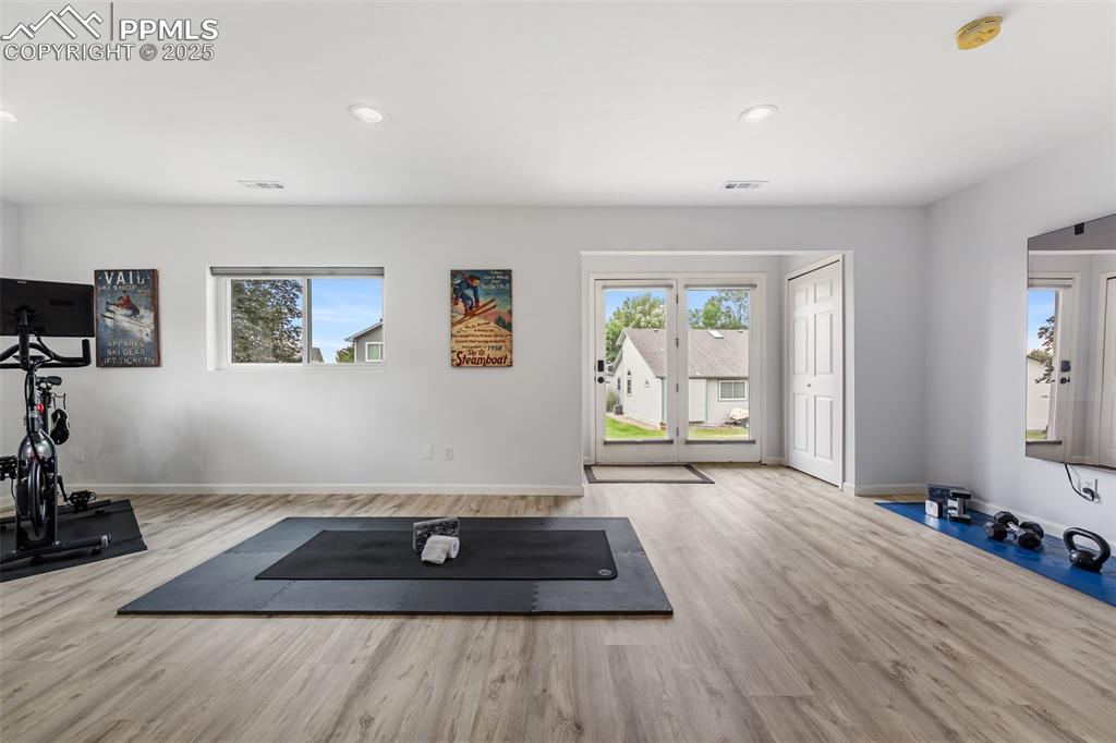 Image 31 of 44: Workout area featuring plenty of natural light, recessed lighting, and wood