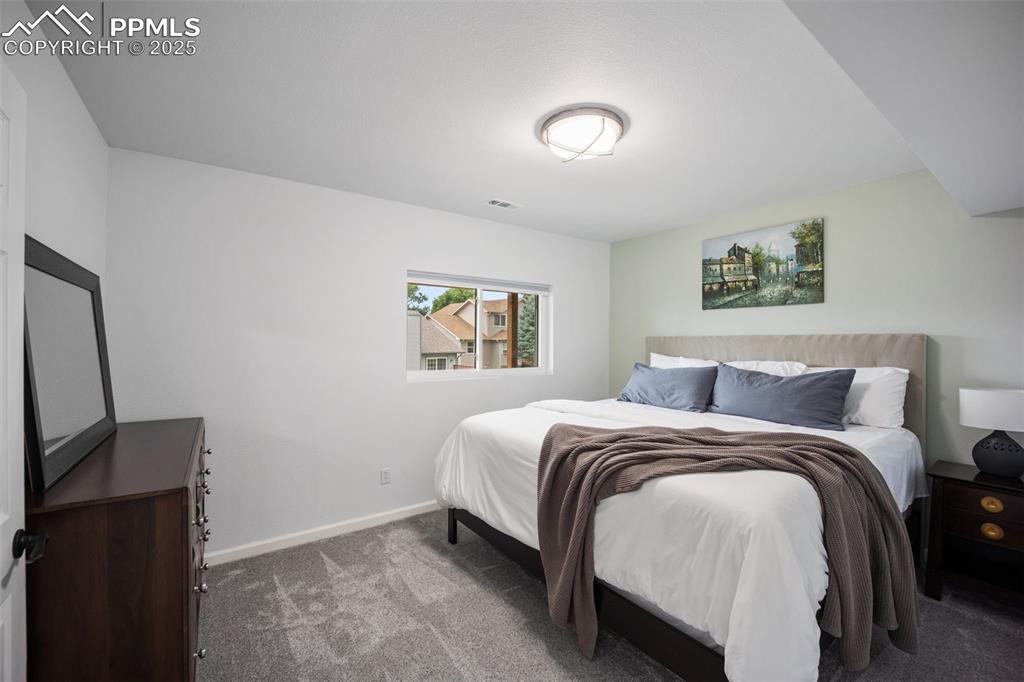 Image 34 of 44: Carpeted bedroom featuring baseboards