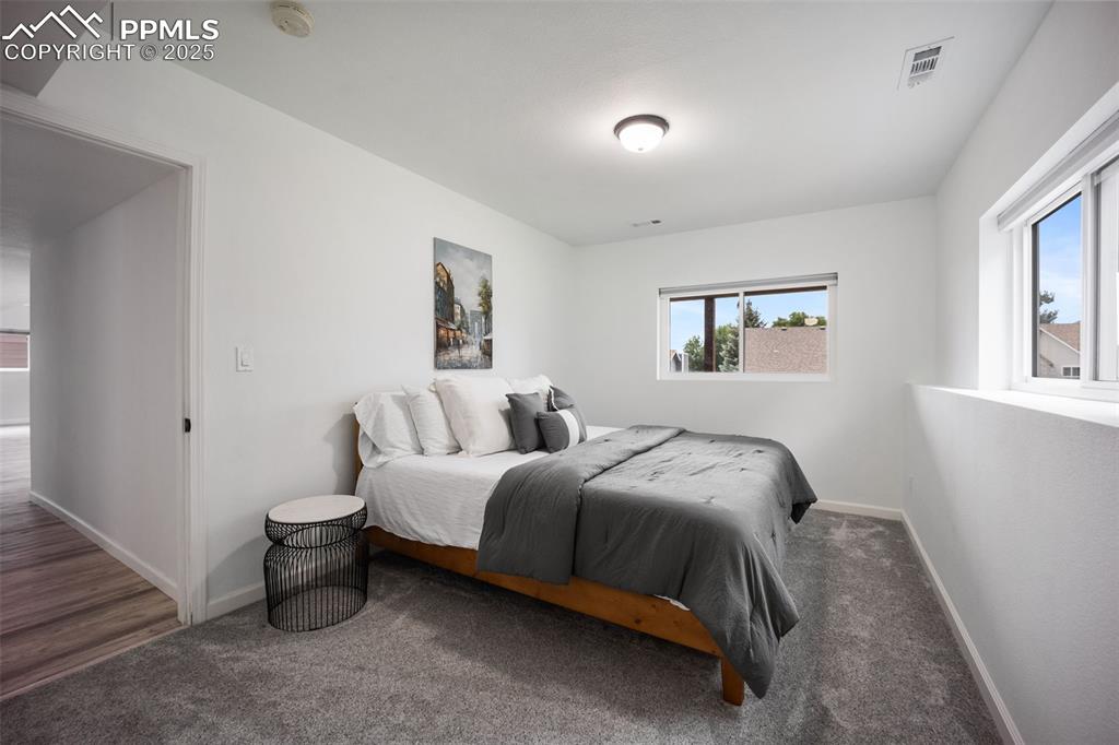 Image 36 of 44: Carpeted bedroom featuring baseboards