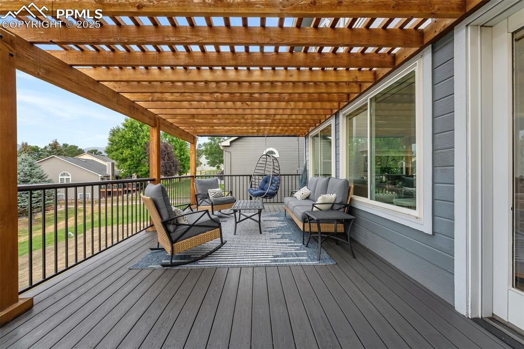 Image 40 of 44: Deck with outdoor lounge area and a pergola