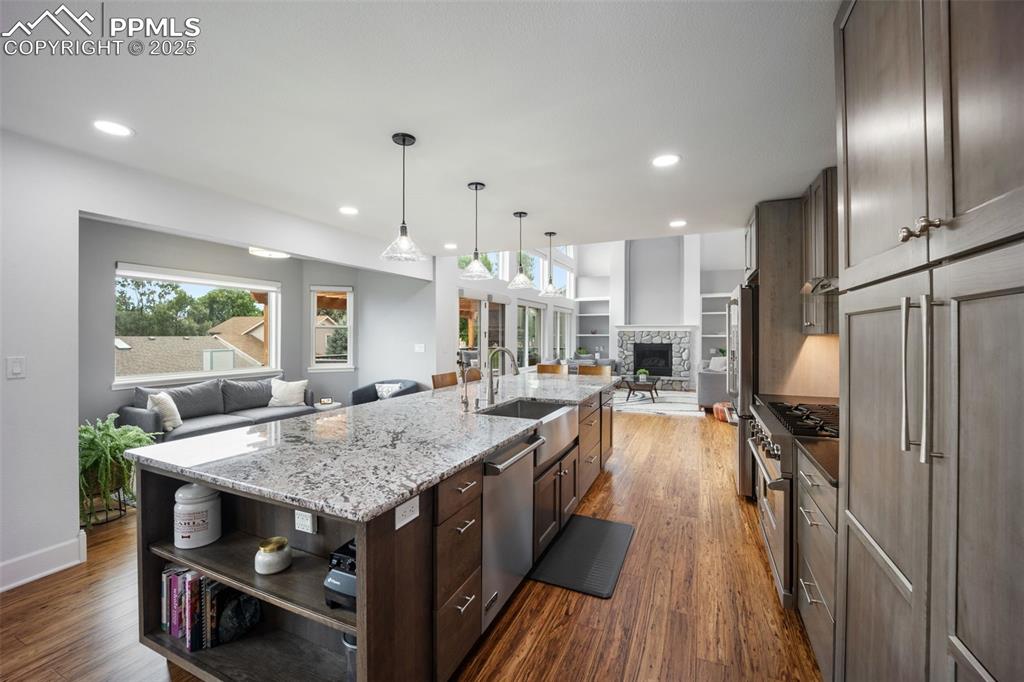 Image 6 of 44: Kitchen featuring open floor plan, dark wood-style floors, plenty of natura