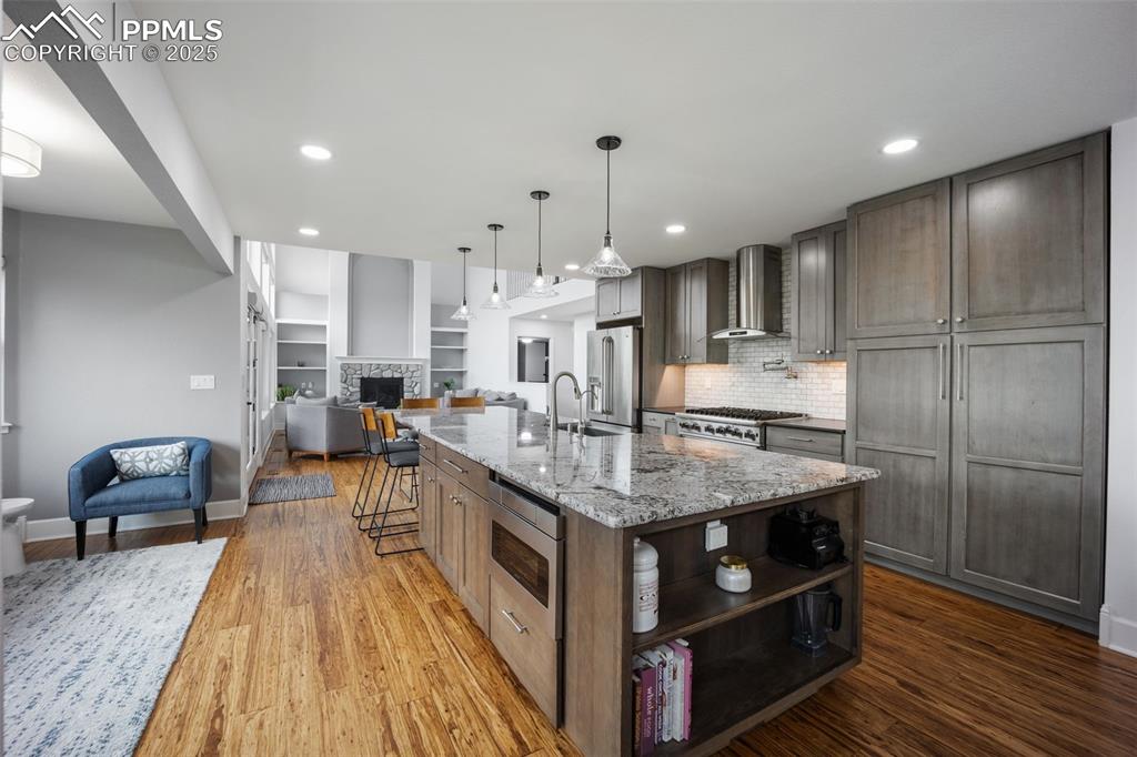 Image 8 of 44: Kitchen with open floor plan, light wood-style flooring, open shelves, ligh