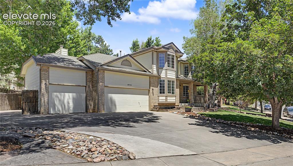 Image 1 of 49: Two-story residence featuring a multi-car garage, brick facade accents, and