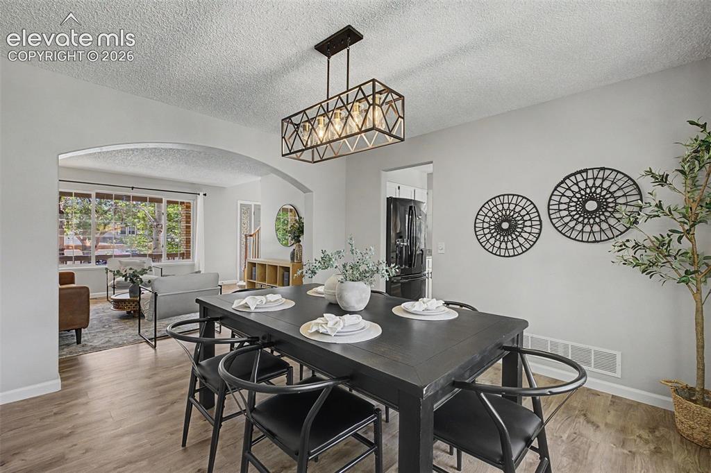 Image 16 of 49: Dining area featuring wood-finish flooring, a rectangular light fixture wit
