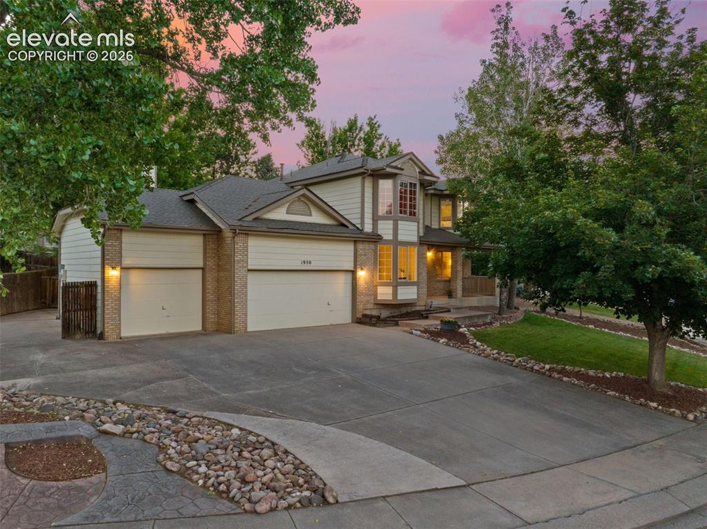 Image 2 of 49: Traditional-style residence featuring a multi-car driveway with stamped con