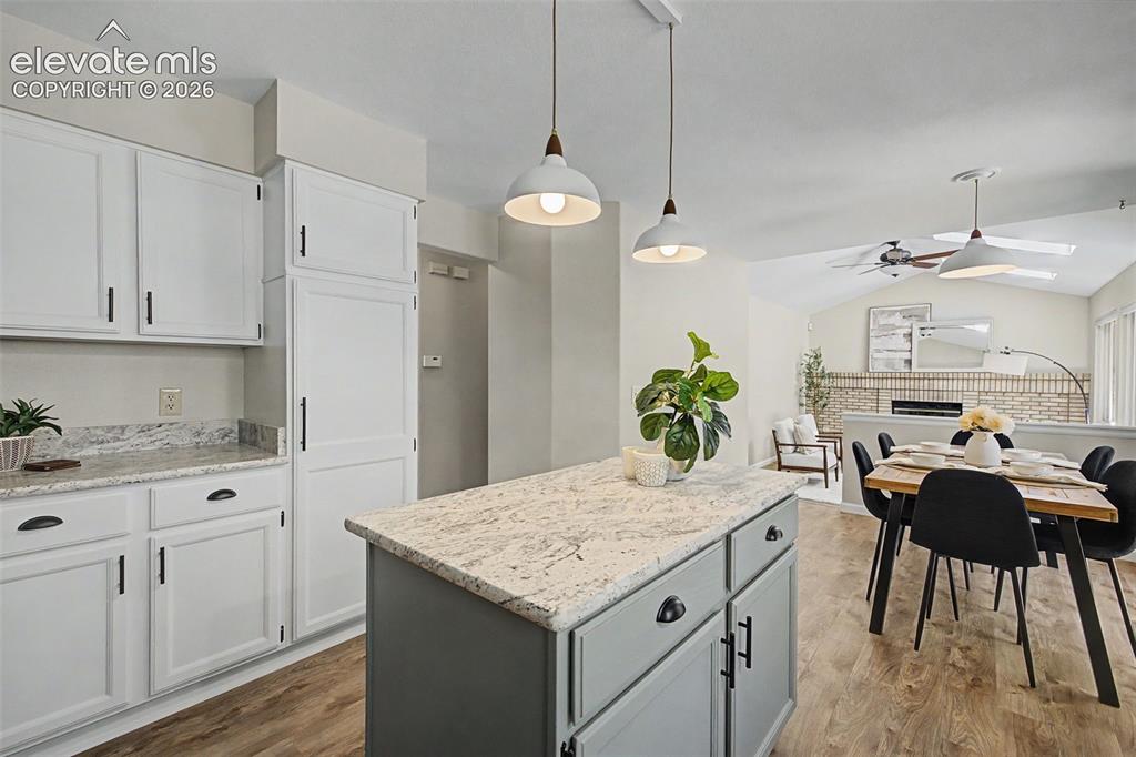 Image 23 of 49: Spacious kitchen featuring white cabinetry, light-toned countertops, and a