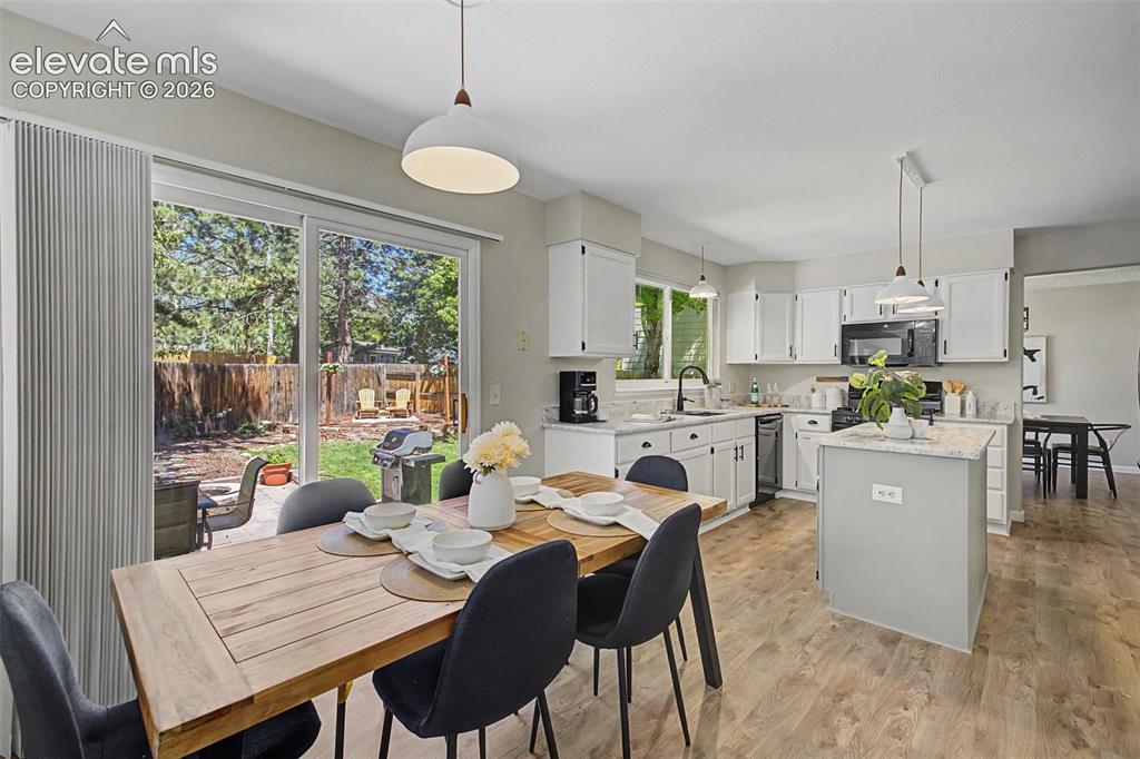 Image 25 of 49: Open-concept living space featuring wood-finish flooring, a kitchen island