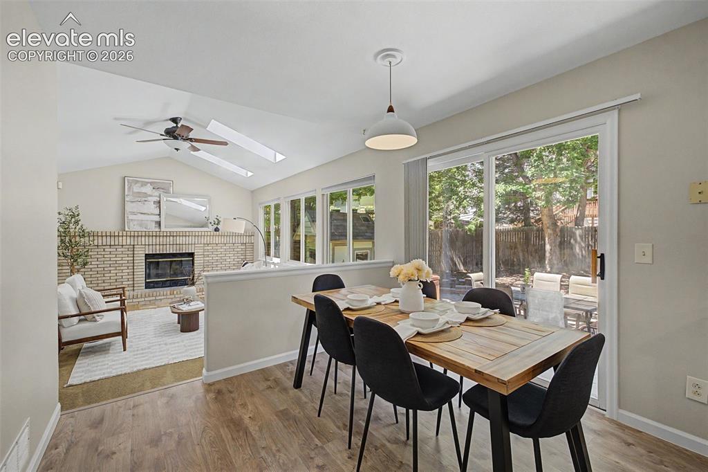 Image 26 of 49: Dining area featuring wood-finish flooring, a white pendant light fixture,