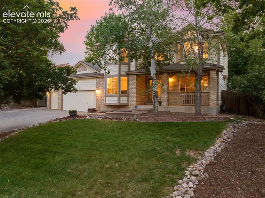 Image 3 of 49: Two-story residence featuring light-toned siding and brick accents
