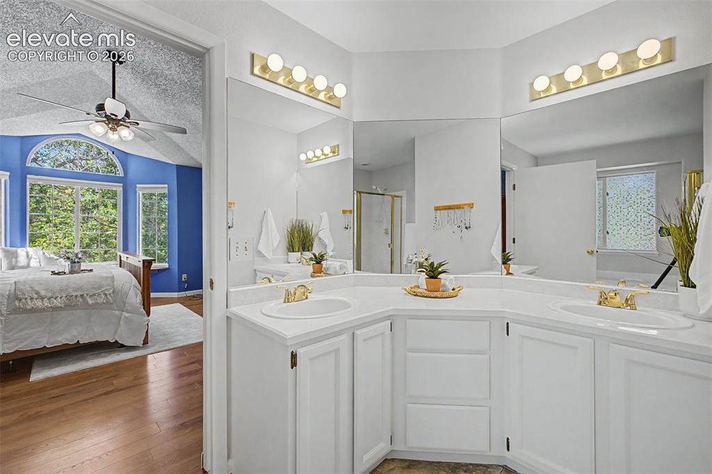 Image 33 of 49: Dual vanity with white cabinetry and integrated sinks