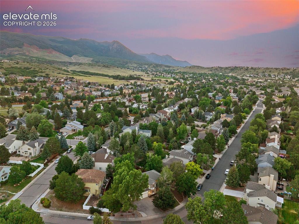 Image 46 of 49: Expansive aerial capture of a residential neighborhood featuring establishe